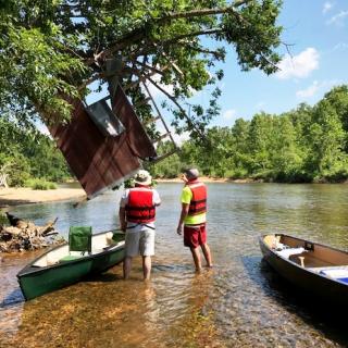 Missouri Department of Natural Resources staff survey flood debris on the Jacks Fork River