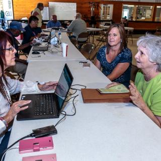 Flood survivors register for assistance at a Disaster Recovery Center in Van Buren